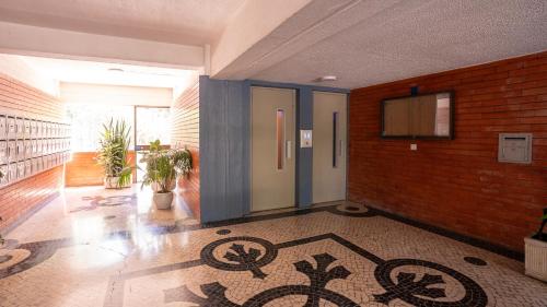 a hallway with a room with a tile floor and a door at airport room in Lisbon