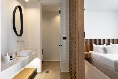 a bathroom with a sink and a bed at ARion Aesthesis Superior Villa Heated Pool in Kókkinon Khoríon