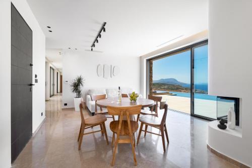 a kitchen and dining room with a table and chairs at ARion Aesthesis Superior Villa Heated Pool in Kókkinon Khoríon