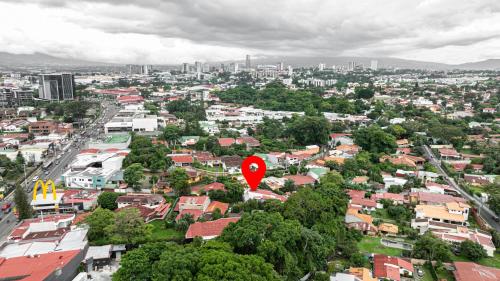 a city with a red marker in the middle of a city at Home 333 Habitacion 331 in Escazu