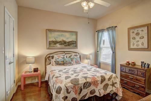 a bedroom with a bed and a ceiling fan at Palm Bay 307 in Padre Island