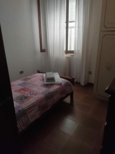 a bedroom with a bed with a book on it at All ombra del carrubo in Ottava Sassari
