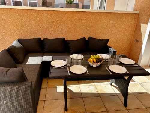 a table with plates of food on top of a couch at Sunny Stay in Torre De La Horadada in Torre de la Horadada