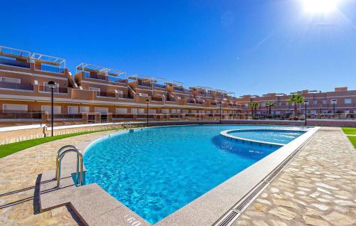 a large swimming pool in front of a building at Sunny Stay in Torre De La Horadada in Torre de la Horadada