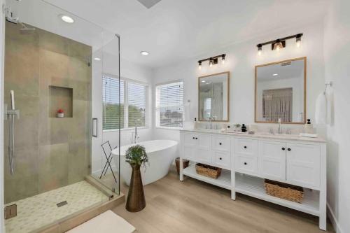 a bathroom with a tub and two sinks and a shower at Casa Malca Tulum in Indio