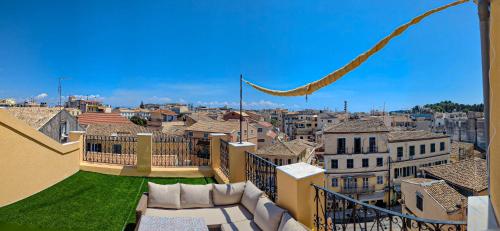 a view of a city from the balcony of a building at Ionian Pearl Apartments And Suites in Corfu Town