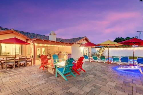 a patio with colorful chairs and tables and umbrellas at Happy Hour in Bermuda Dunes