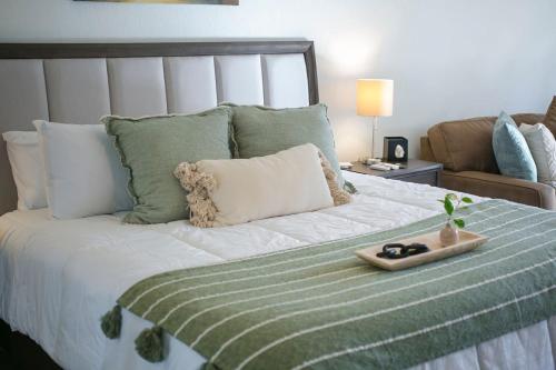 a bedroom with a bed with a tray on it at Happy Hour in Bermuda Dunes