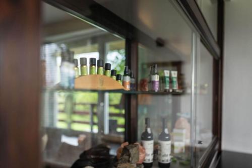 a glass cabinet filled with bottles of wine at Gruppenhaus Haus BerchStein in Winterberg