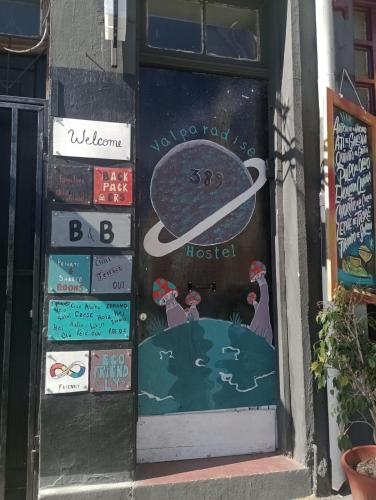 a door to a hostel with signs on it at Valparadise Hostel in Valparaíso