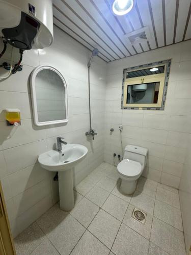 a bathroom with a sink and a toilet at نجوم السعد 8 in Al Masfalah