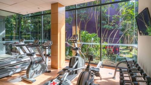 a gym with cardio machines and large windows at Holiday Inn Express Phuket Patong Beach Central by IHG in Patong Beach
