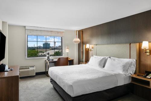 a hotel room with a large bed and a window at Holiday Inn Niagara Falls State Park Entry by IHG in Niagara Falls