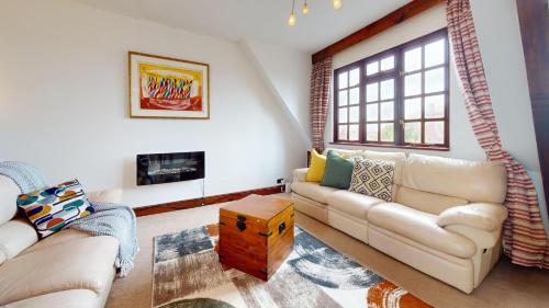 a living room with a couch and a fireplace at Spacious 4-Bedroom Penthouse Sleeps 8 - Great City View and Free Parking in Portsmouth