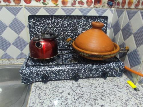 a tea pot and a tea kettle on a counter at Amina appartement in Azrou