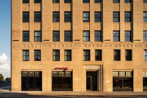 a large brick building with doors and windows at Moxy Springfield Downtown in Springfield