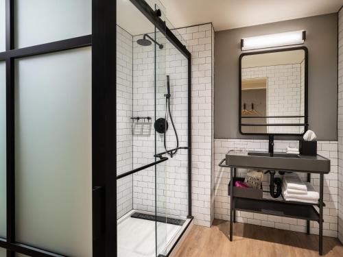 a bathroom with a shower and a sink at Moxy Springfield Downtown in Springfield