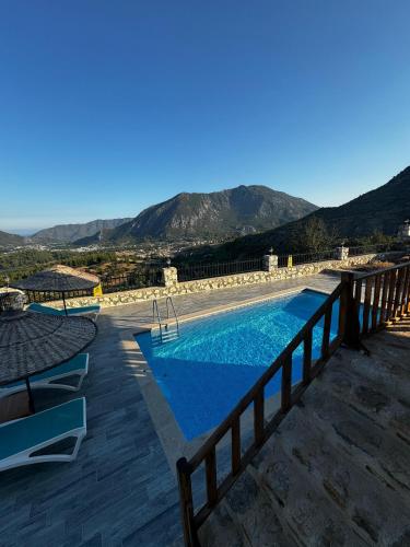 a view of a swimming pool with mountains in the background at VILLA TERAS in Adrasan