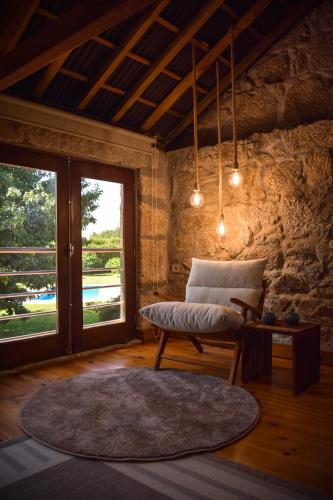 a living room with a bench and a window at QUINTA DO RIBEIRO Garden House in Lousada