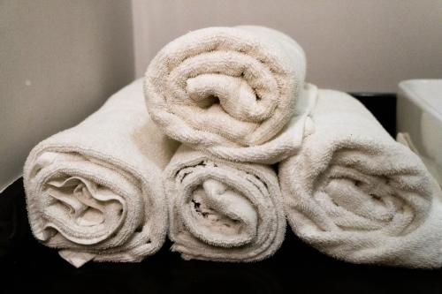 a pile of towels sitting on top of a table at Infinity Suites habitación triple in Cancún