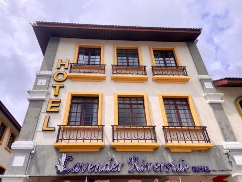 a building with balconies on the side of it at Lavender Riverside Hotel in Melaka