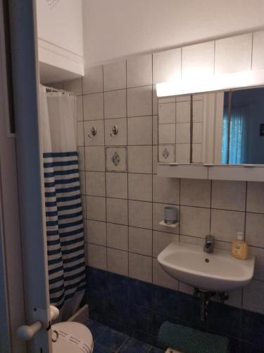a bathroom with a sink and a toilet at Iro's Cute House in Parikia