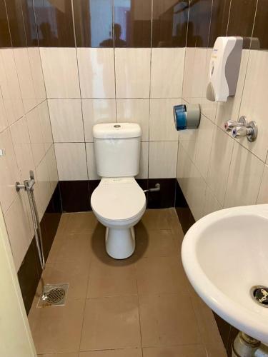 a bathroom with a toilet and a sink at Lavender Riverside Hotel in Melaka