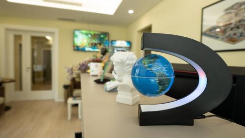 a exhibit in an office with a globe on a counter at F&M Hotel 2 in Tirana