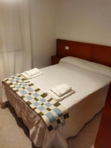 En eller flere senge i et værelse på Alojamiento caral