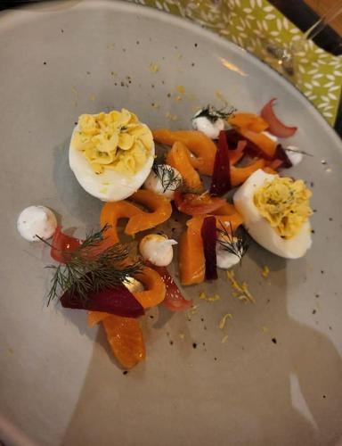 a white plate with eggs and vegetables on it at Cottage in Nature, free sauna, free breakfast in Lielkangari