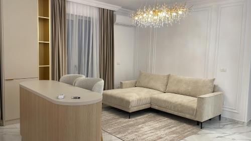 a living room with a couch and a chandelier at Vanilla Studio in Timişoara
