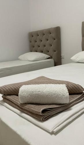 a pile of towels sitting on top of a bed at Apartments Drini in Ulcinj