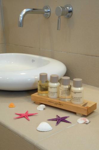 a bathroom counter with starfish and a sink at Vencia Boutique Hotel in Mýkonos City