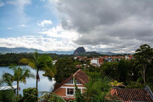 a view of a city with a mountain in the background at Hotel Spa Bliss Guatape in Guatapé
