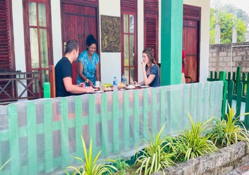 a group of people standing around a table at Jm Resort in Dambulla