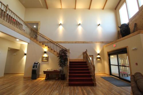 a hallway with a staircase in a building at Bowman Lodge & Convention Center in Bowman