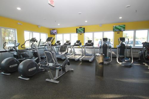 a gym with rows of treadmills and exercise machines at Bowman Lodge & Convention Center in Bowman