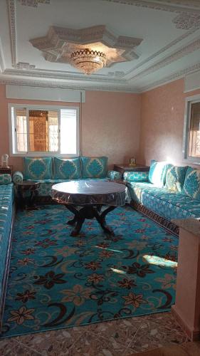 a living room with a couch and a table at Appart Tanger Cosy in Tangier
