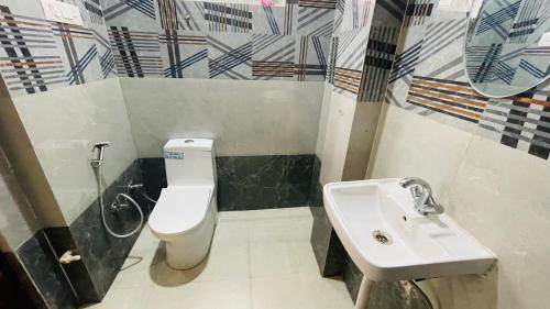 a bathroom with a toilet and a sink at TWO BHK ABODE in GOLF CITY LUCKNOW in Lucknow