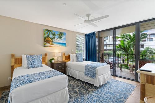 a hotel room with two beds and a balcony at Perfect Getaway 2BD Condo, Steps to Beach & Shops in Wailea