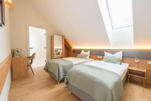 a hotel room with two beds and a window at Naturparkbauernhof Pöltl in Pöllau