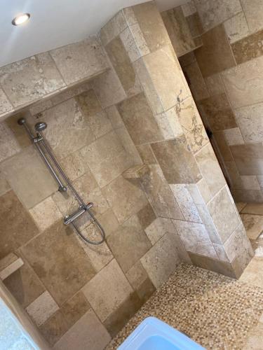 a shower in a bathroom with a glass door at Everley Cottage in Scarborough