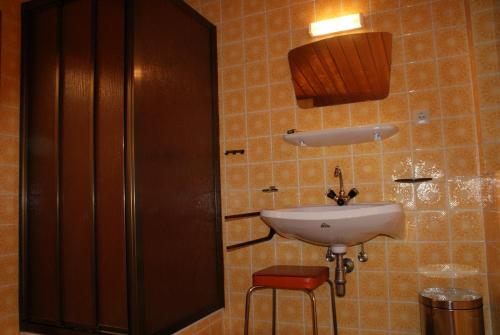 a bathroom with a sink and a red stool at Ferienhaus Waldesruh in Sautens