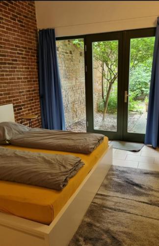 a bedroom with two beds and a window at Loft Wellness City Center in Leipzig