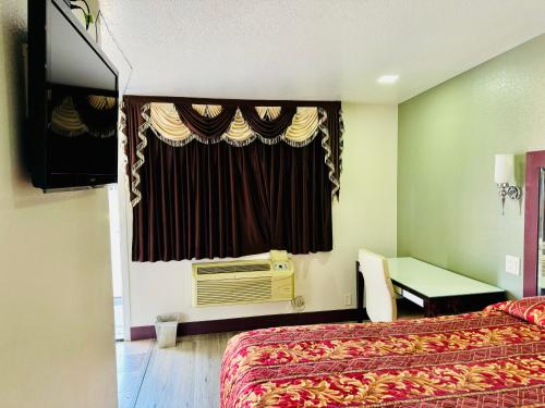 a hotel room with two beds and a window at A Fisher's Inn Motel in Las Vegas