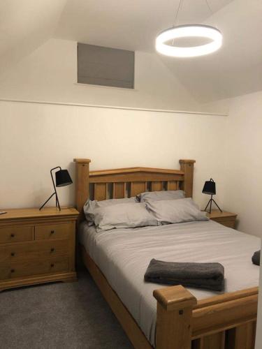 a bedroom with a wooden bed with two lamps on it at Old chemist in Lybster