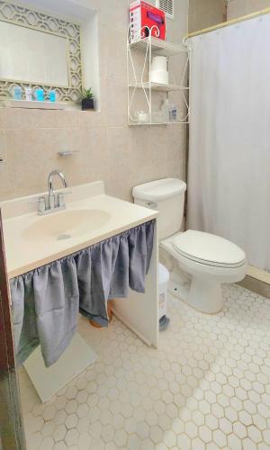 a bathroom with a sink and a toilet at Sierra Bayamón in Bayamon