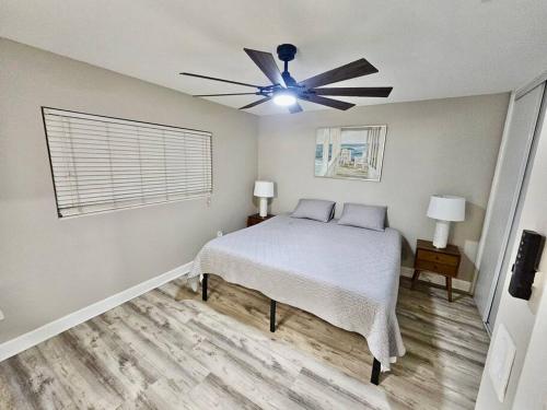 a bedroom with a bed and a ceiling fan at Midtown Marvel Reinvented with Contemporary Charm in Gainesville