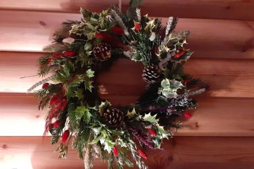 a christmas wreath is hanging on a wall at Orchid lodge in Bridge of Tilt