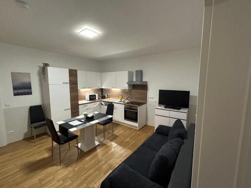 a living room with a couch and a table at Paky Appartements 00313 in Bruck an der Leitha
